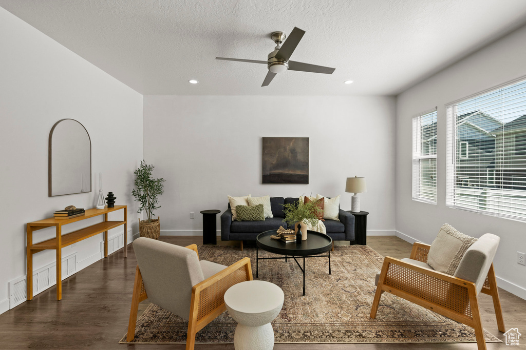 Living room featuring wood finished floors, ceiling fan, recessed lighting, baseboards, and a textured ceiling