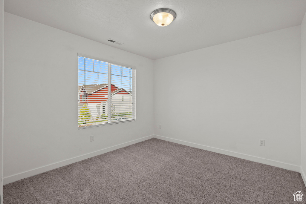 Unfurnished room featuring carpet flooring and baseboards