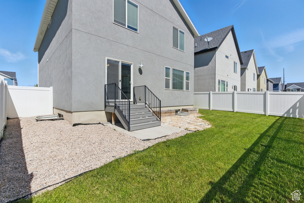 Rear view of property with stucco siding and a residential view