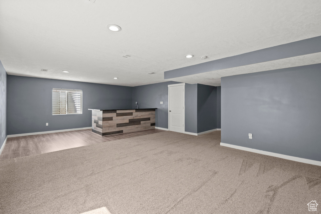 Below grade area featuring carpet floors, baseboards, and recessed lighting