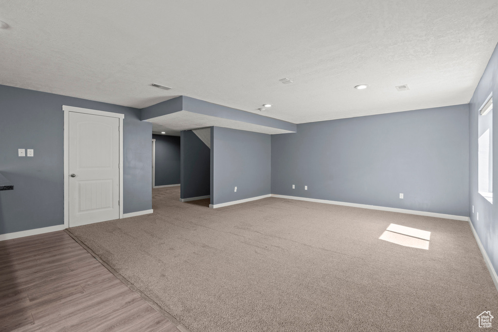 Spare room featuring baseboards and wood finished floors