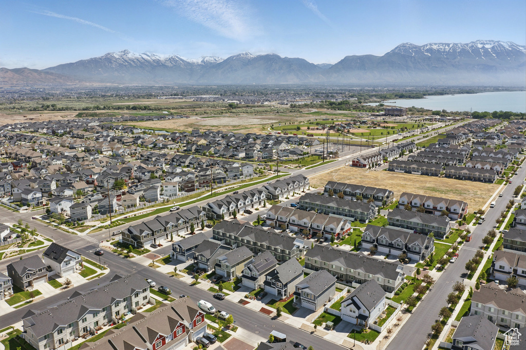 Aerial view of property's location featuring nearby suburban area and a water and mountain view