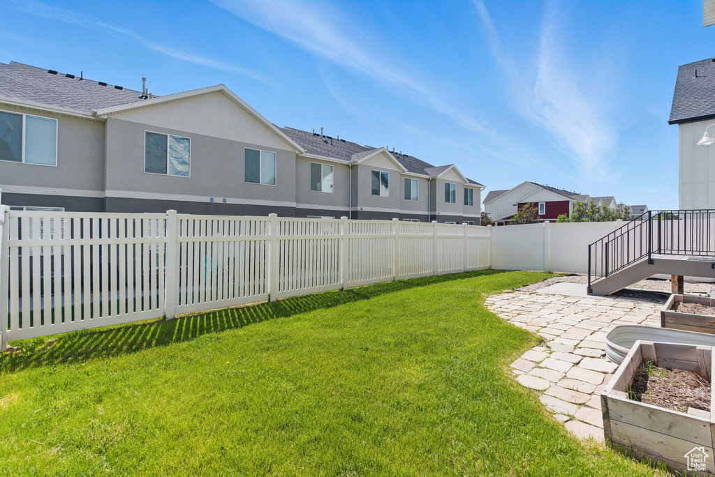 View of yard with a residential view, a patio area, and a garden