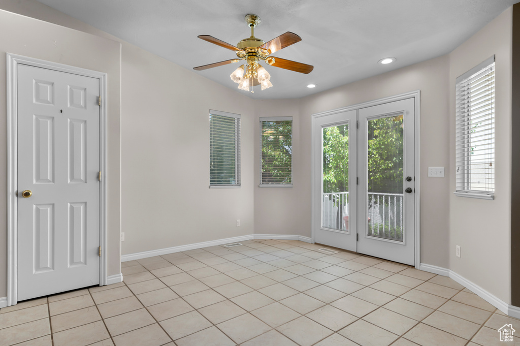 Empty room featuring a ceiling fan, baseboards, light tile patterned floors, and recessed lighting