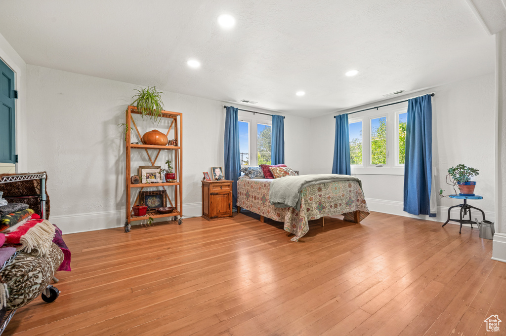 Bedroom featuring baseboards, recessed lighting, and light wood-style floors