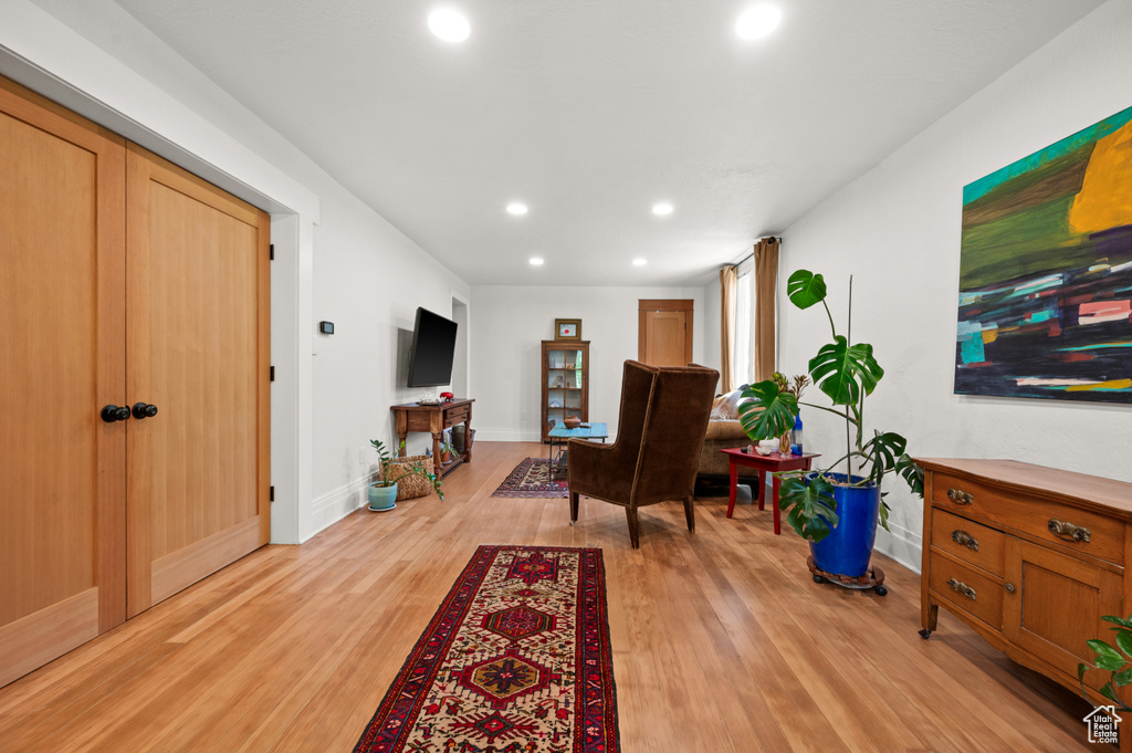 Living room featuring light wood finished floors, recessed lighting, and baseboards