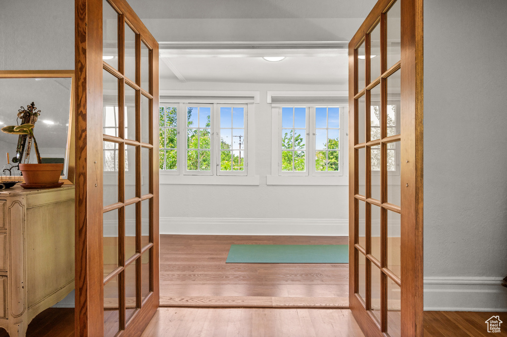Workout area featuring french doors, wood finished floors, and baseboards