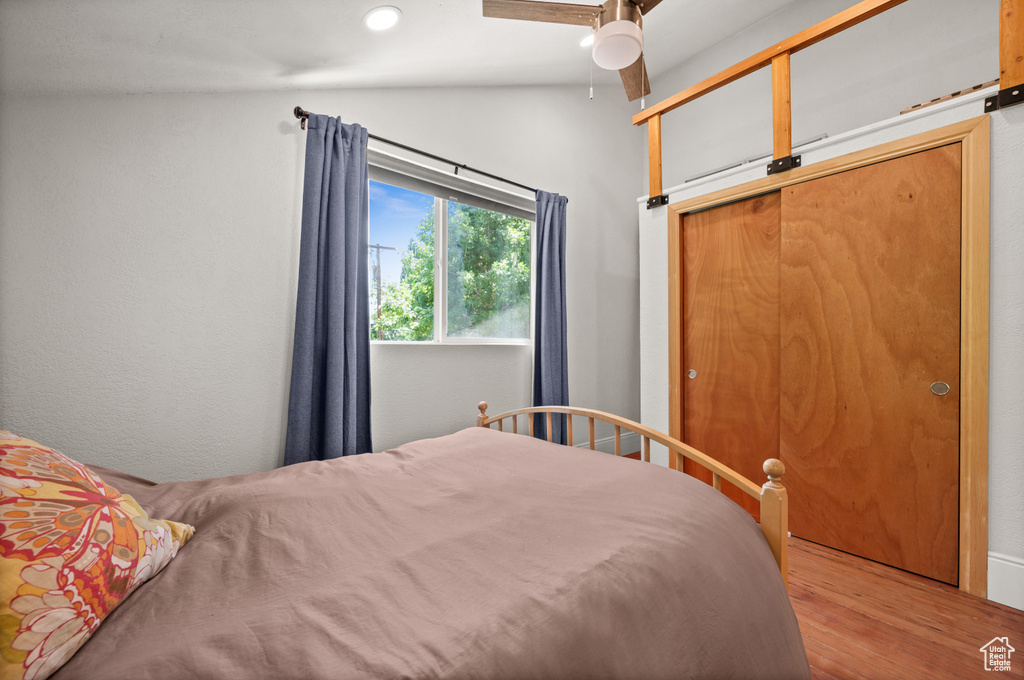 Bedroom featuring lofted ceiling, wood finished floors, recessed lighting, and a ceiling fan