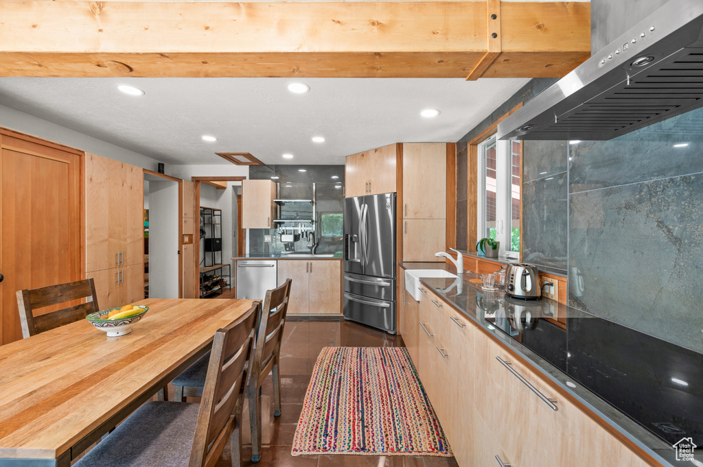 Kitchen with stainless steel appliances, extractor fan, light brown cabinetry, a sink, and recessed lighting