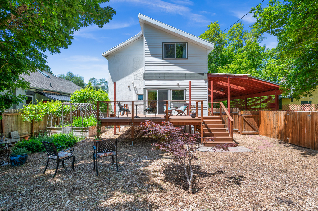 Rear view of property with a wooden deck