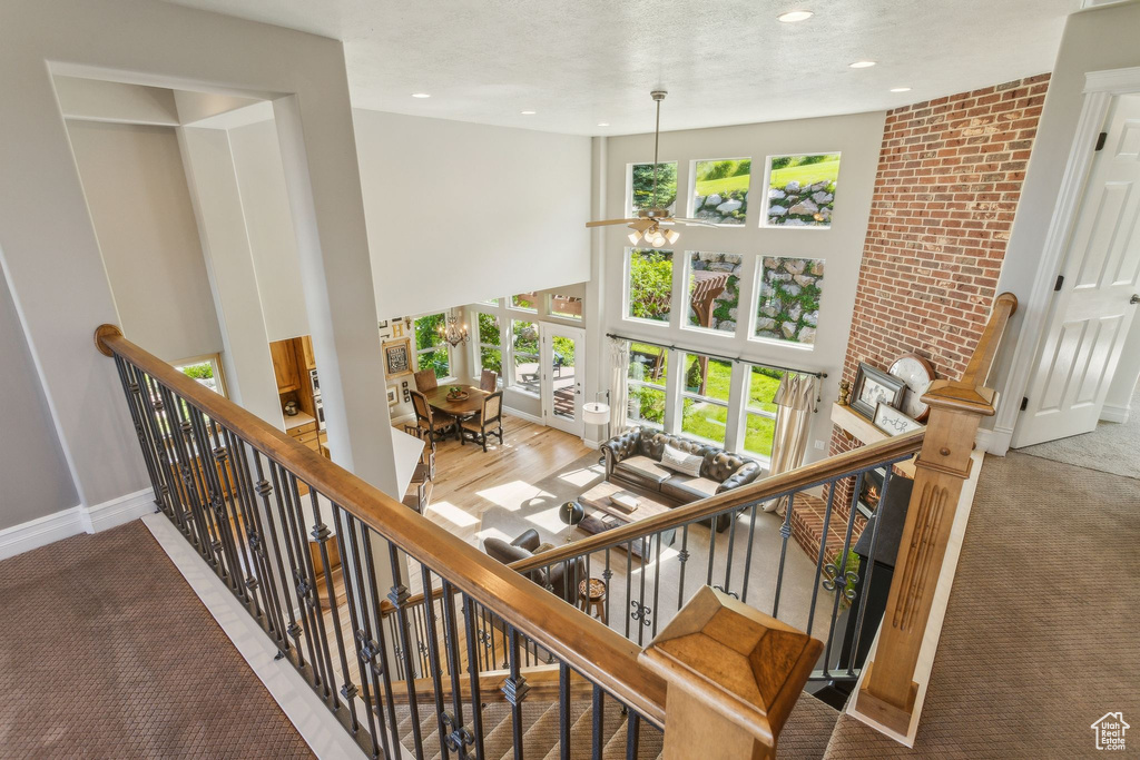 Stairs featuring carpet floors, baseboards, and recessed lighting