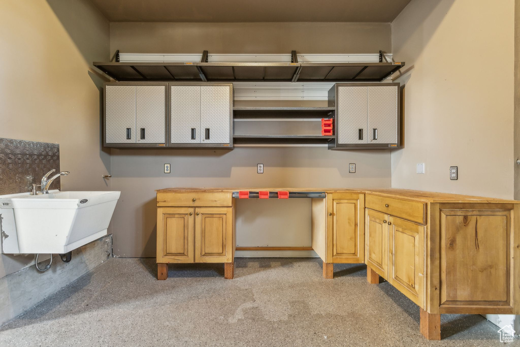 Kitchen featuring open shelves and a sink