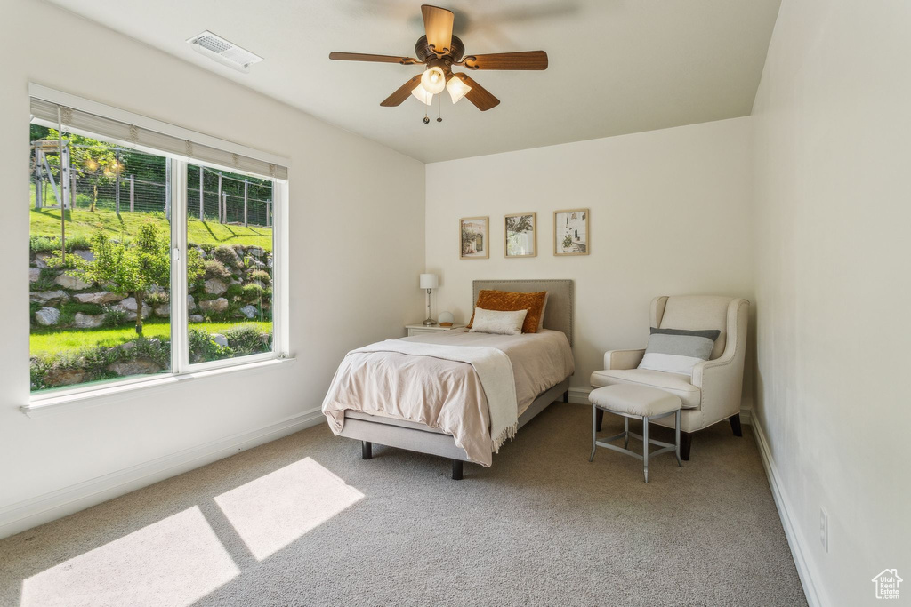 Bedroom with carpet, baseboards, and ceiling fan