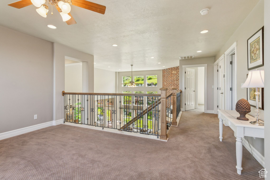 Hallway with carpet flooring, baseboards, and recessed lighting