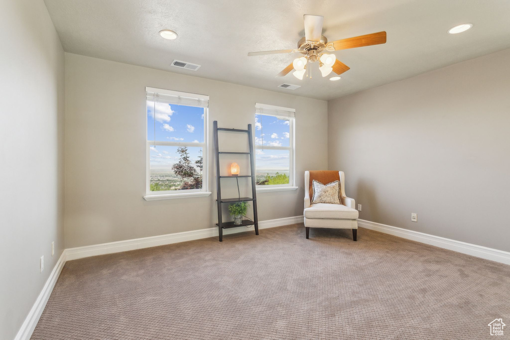 Living area featuring carpet, a ceiling fan, baseboards, and recessed lighting