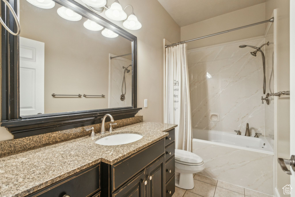 Full bathroom with shower / tub combo, vanity, tile patterned flooring, and toilet
