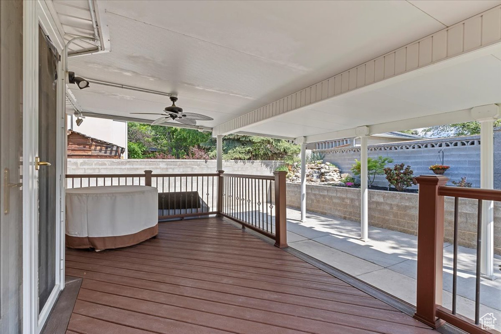 Wooden terrace featuring a ceiling fan
