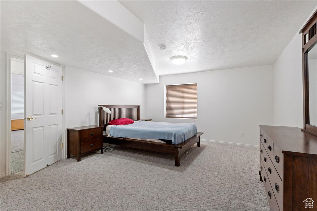 Bedroom featuring carpet, baseboards, a textured ceiling, and recessed lighting