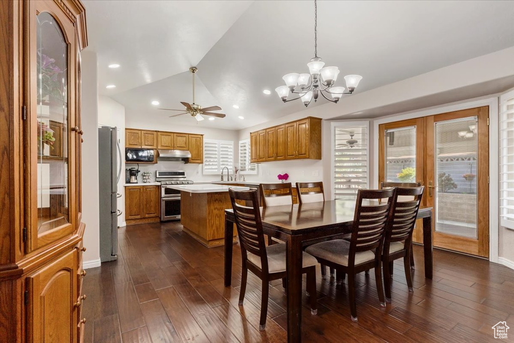 Dining area with a chandelier, dark wood-style flooring, ceiling fan, lofted ceiling, and recessed lighting