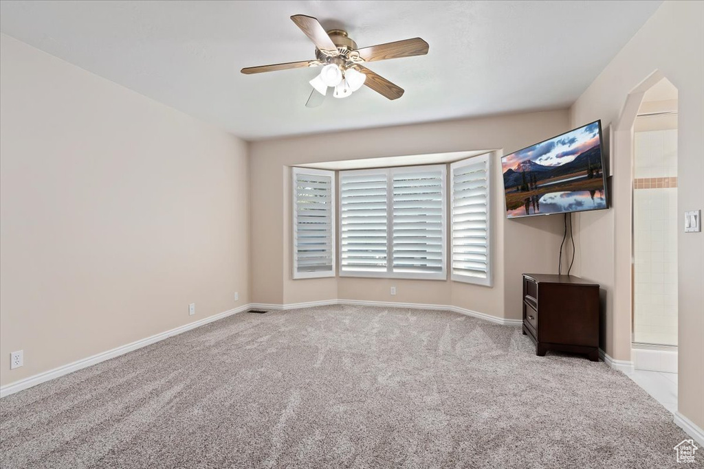Unfurnished bedroom featuring carpet floors, baseboards, and ceiling fan