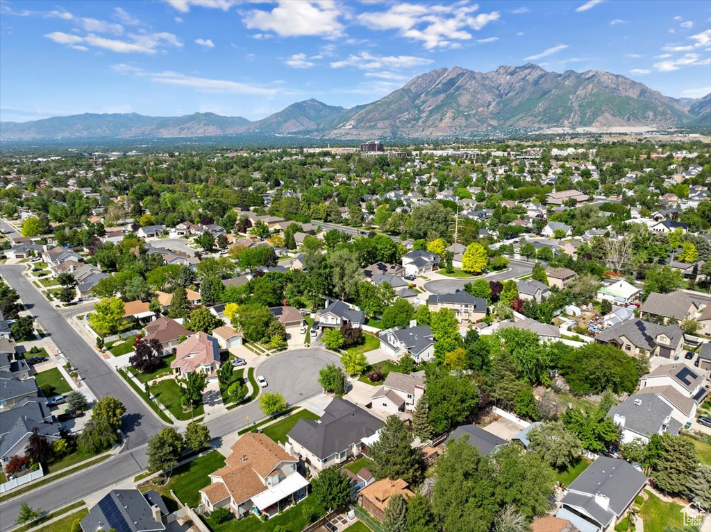 Aerial view of property's location featuring mountains and nearby suburban area