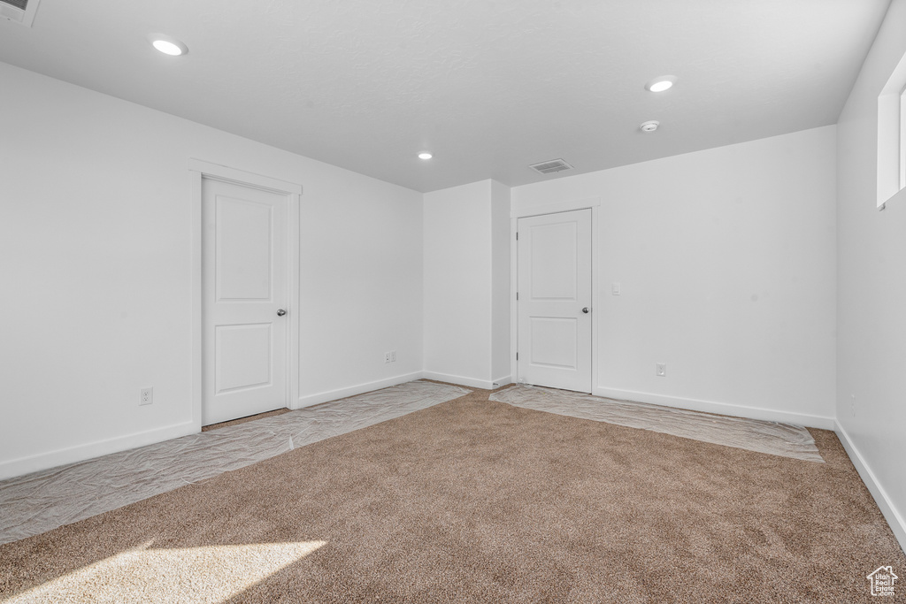 Spare room with light carpet, recessed lighting, and baseboards