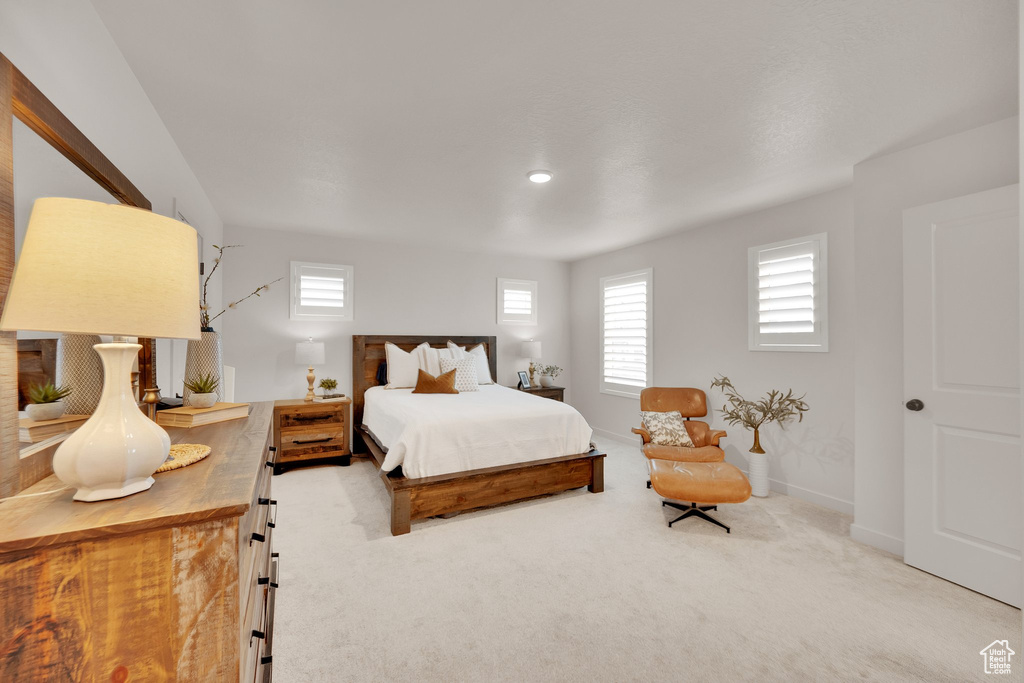 Bedroom featuring light colored carpet and baseboards