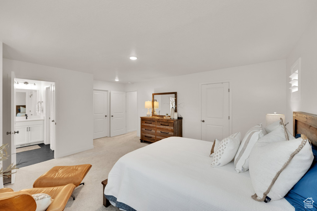 Bedroom featuring carpet flooring, recessed lighting, and connected bathroom