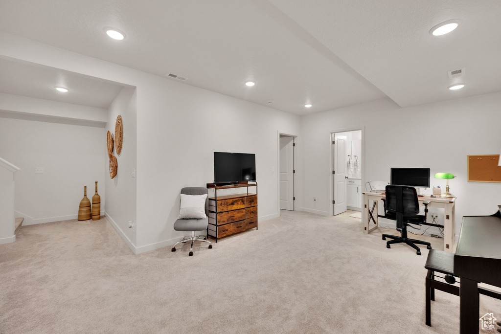 Carpeted office space with baseboards and recessed lighting