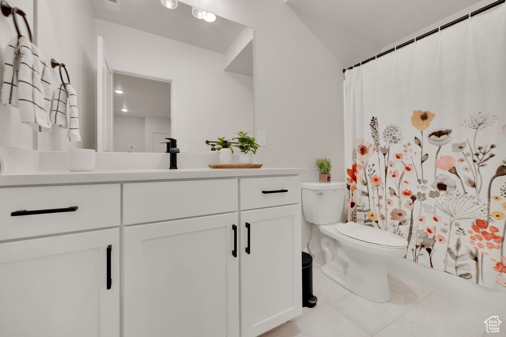 Full bathroom featuring vanity, tile patterned flooring, toilet, and a shower with curtain