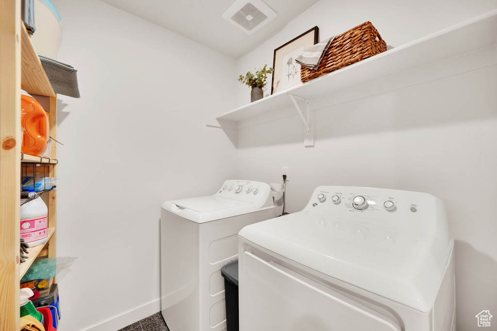 Laundry room featuring separate washer and dryer and baseboards