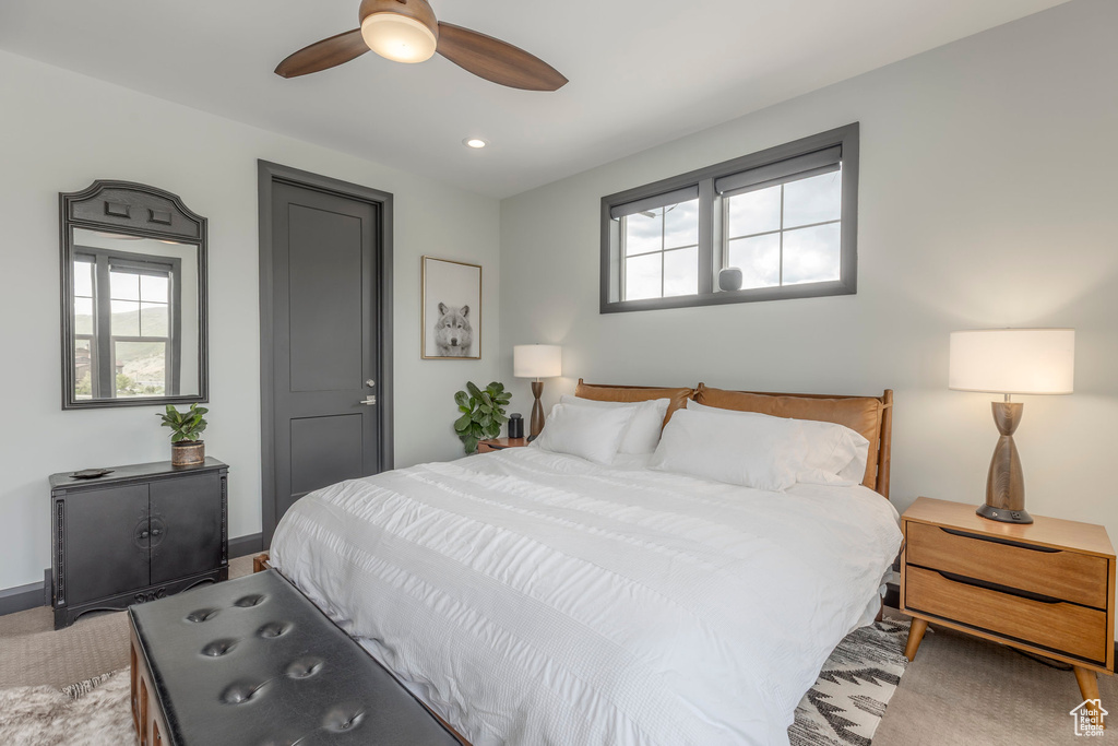 Bedroom with ceiling fan and recessed lighting
