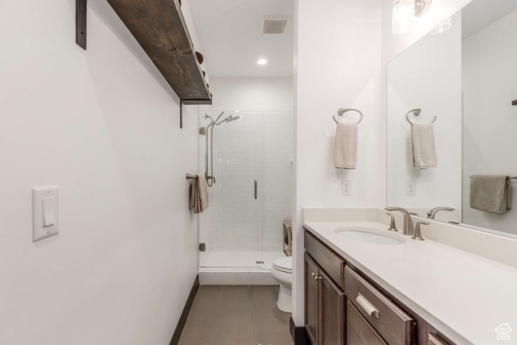 Full bath featuring toilet, tile patterned flooring, vanity, a stall shower, and recessed lighting