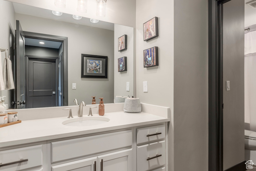 Bathroom featuring vanity and toilet