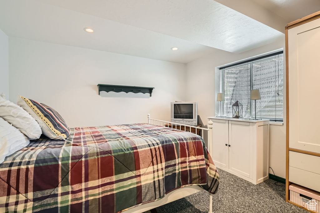 Bedroom featuring dark carpet, recessed lighting, and baseboards