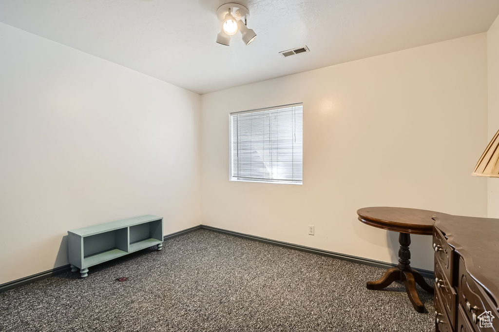 Carpeted home office featuring baseboards