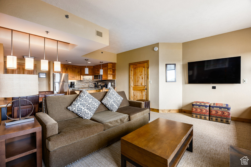 Living room featuring baseboards and carpet floors