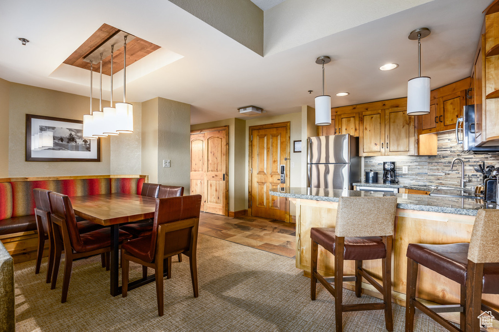 Dining area with recessed lighting and baseboards
