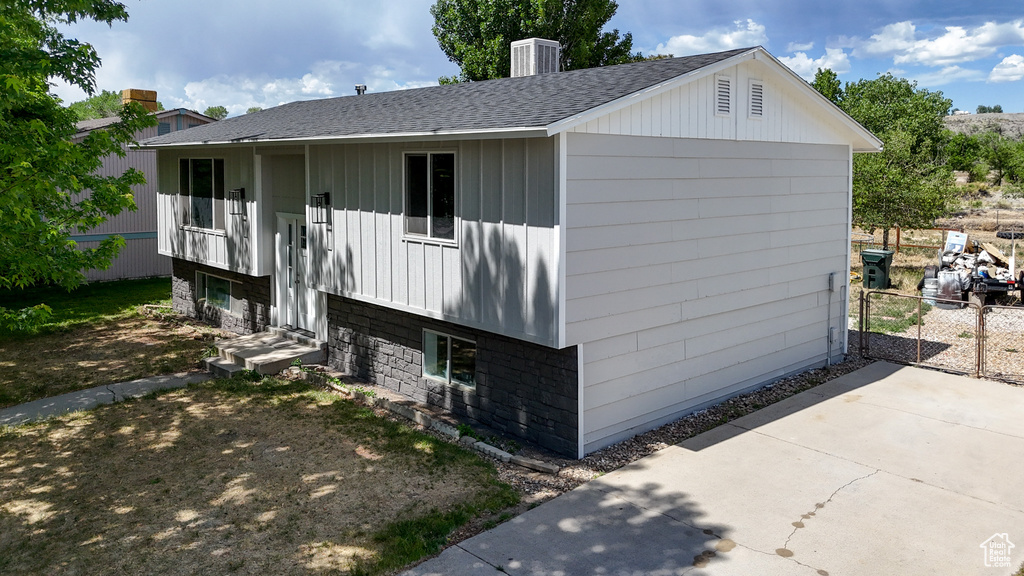 View of home's exterior with roof with shingles