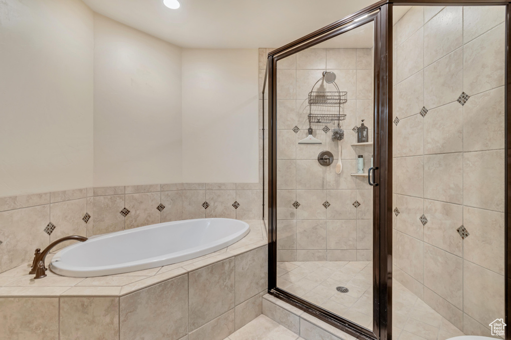 Bathroom with a bath, a stall shower, and recessed lighting