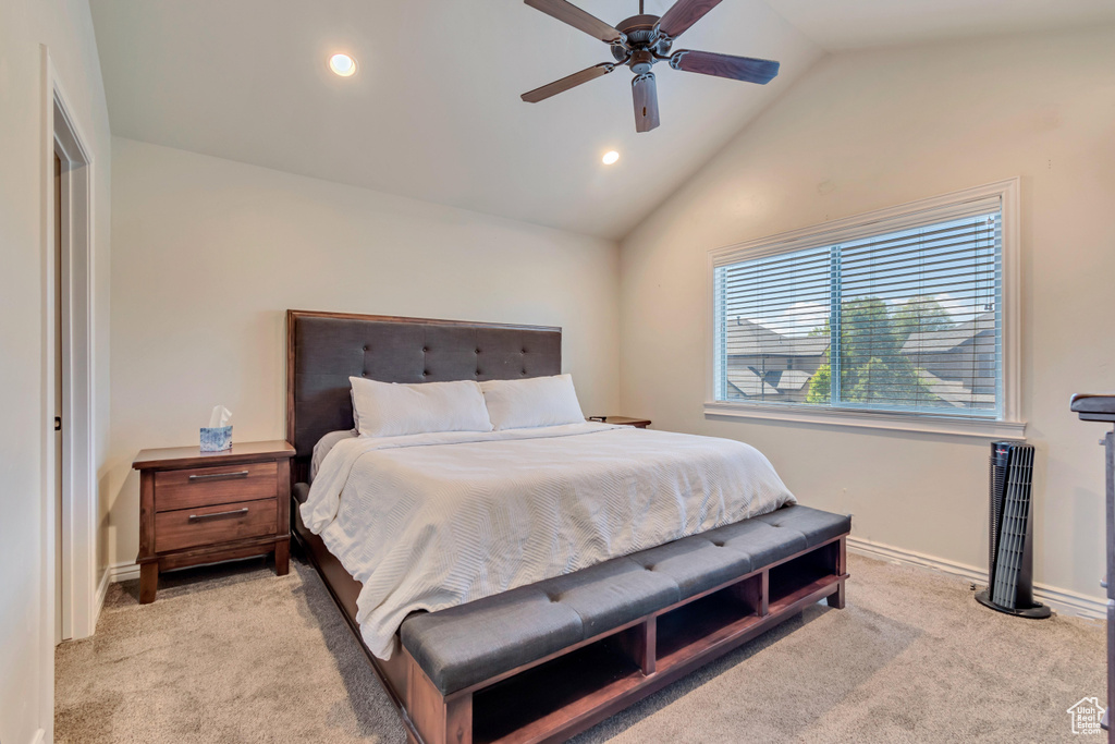 Bedroom with light colored carpet, lofted ceiling, recessed lighting, baseboards, and ceiling fan