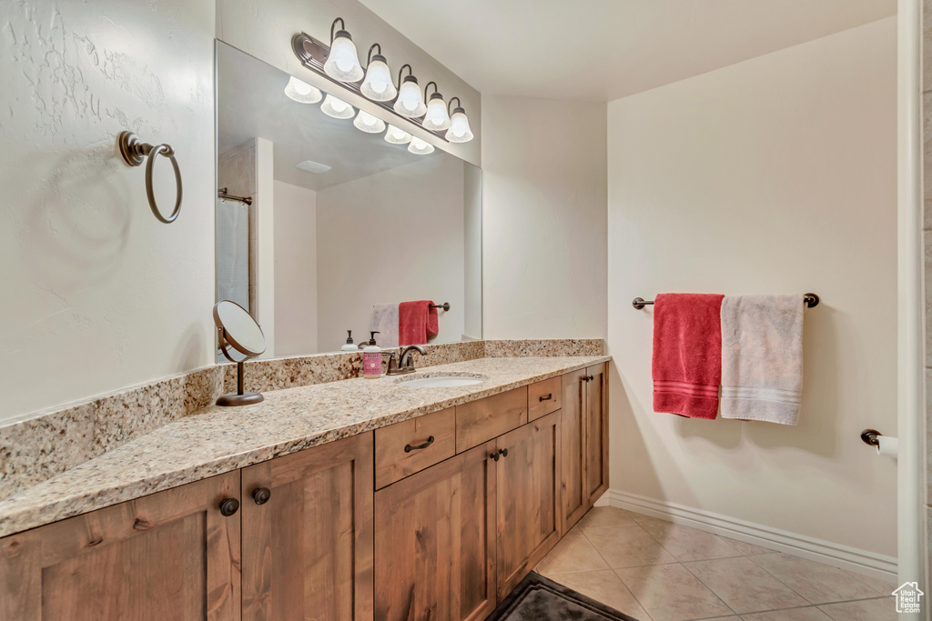 Bathroom featuring tile patterned flooring and vanity