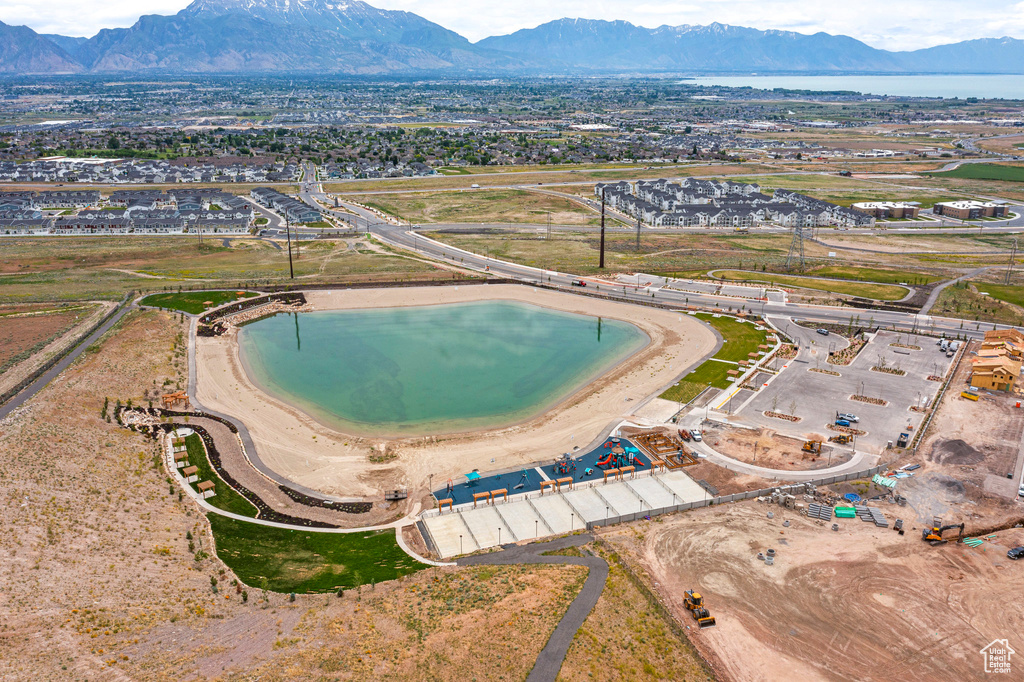 Aerial view of property and surrounding area featuring a mountain backdrop