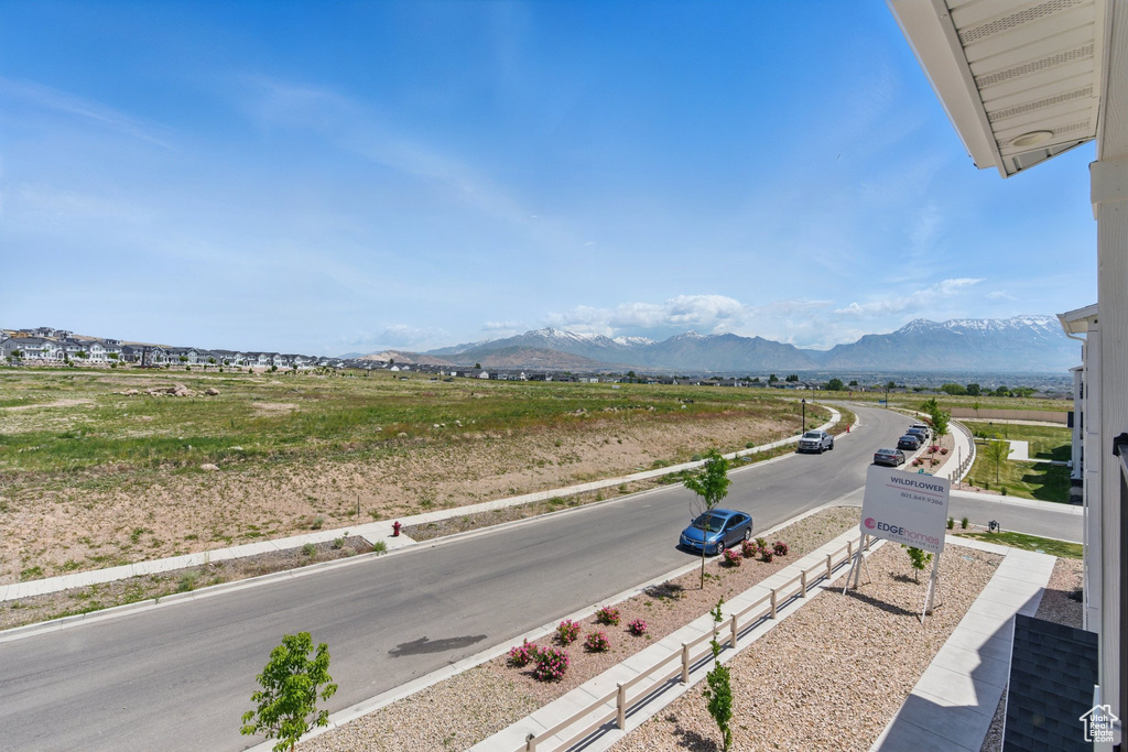 View of asphalt road with a mountain view and sidewalks
