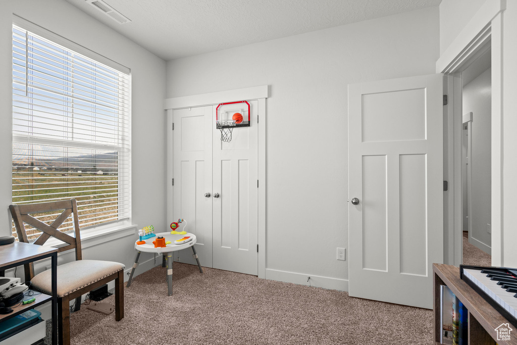 Living area featuring carpet floors and baseboards