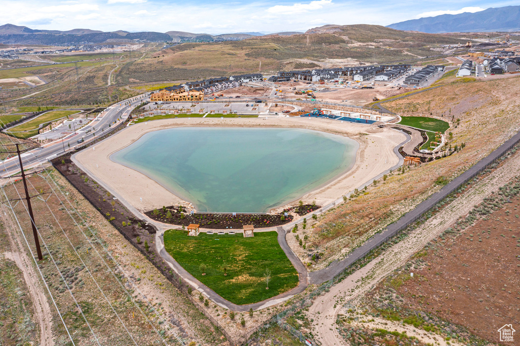 Aerial view of property and surrounding area featuring a mountainous background