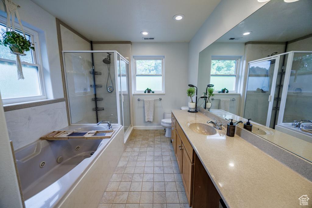 Full bathroom with a stall shower, vanity, a whirlpool tub, toilet, and recessed lighting