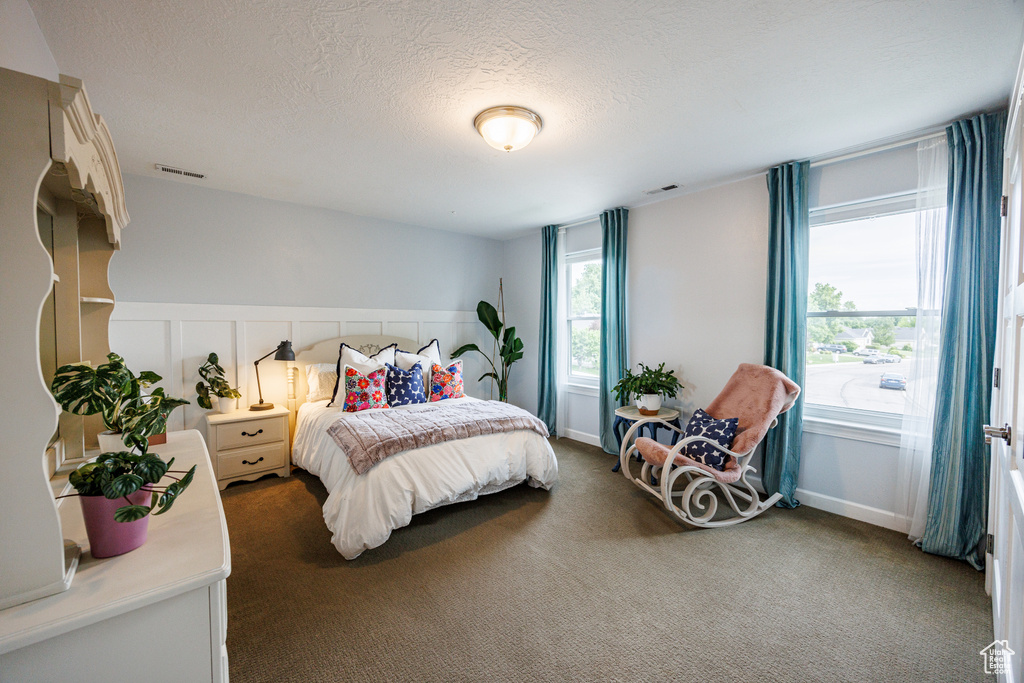 Carpeted bedroom featuring a textured ceiling