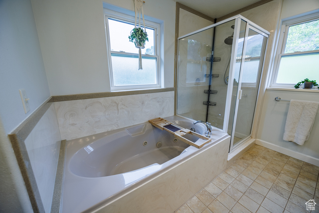 Bathroom with a tub with jets and a shower stall