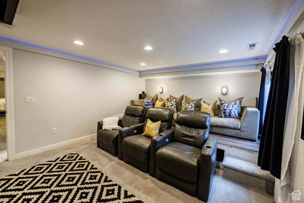 Carpeted home theater room featuring recessed lighting, baseboards, and a textured ceiling
